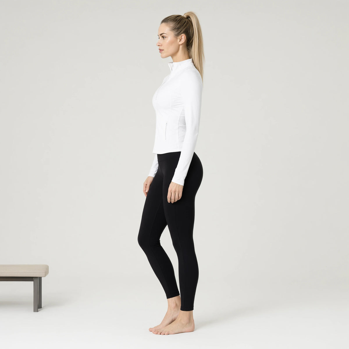 White | Outdoor Running Stretch Tight Zip Long Sleeve Top｜DUVETMOON – side view (ankles gently crossed)