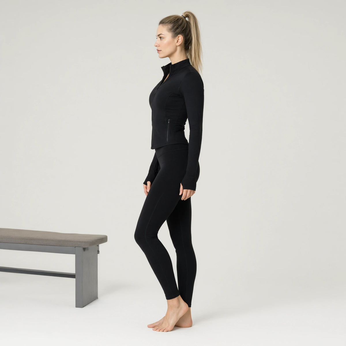 Black | Outdoor Running Stretch Tight Zip Long Sleeve Top｜DUVETMOON – side view (ankles gently crossed)