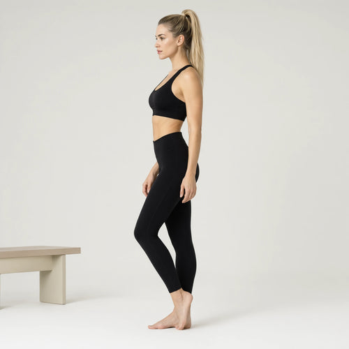 Black | 2-Piece Quick-Dry Bra & Leggings Set for Women｜DUVETMOON – side view (ankles gently crossed)
