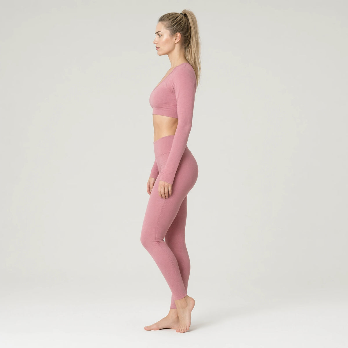 Pink | Running Yoga Navel Seamless Long Sleeve Top｜DUVETMOON – side view (ankles gently crossed)