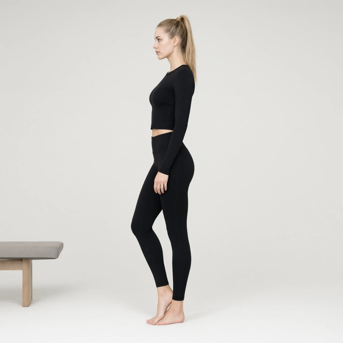 Black | Gradient Long Sleeve Yoga Top｜DUVETMOON – side view (ankles gently crossed)