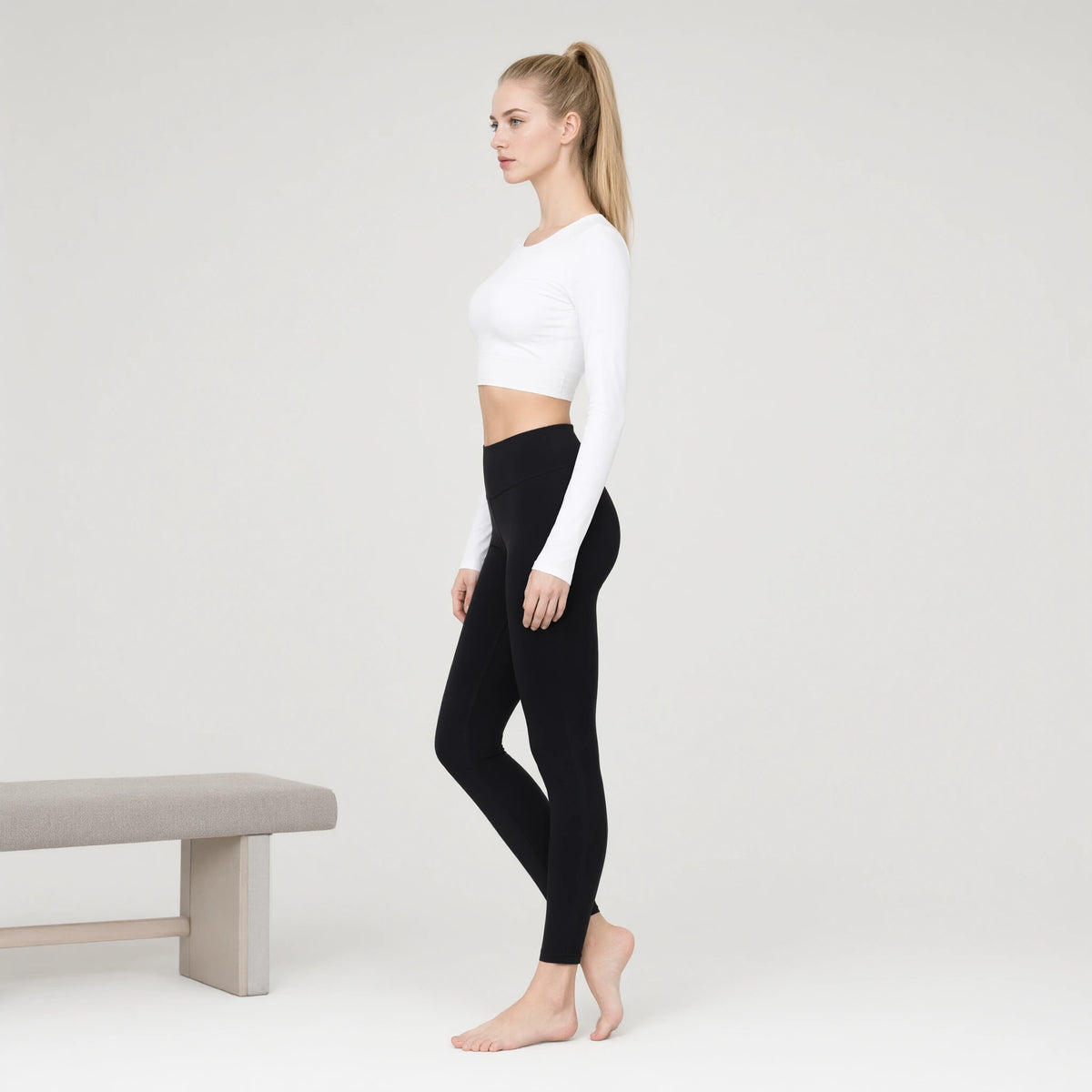 White | Long Sleeve Sports Running Crop Top｜DUVETMOON – side view (ankles gently crossed)