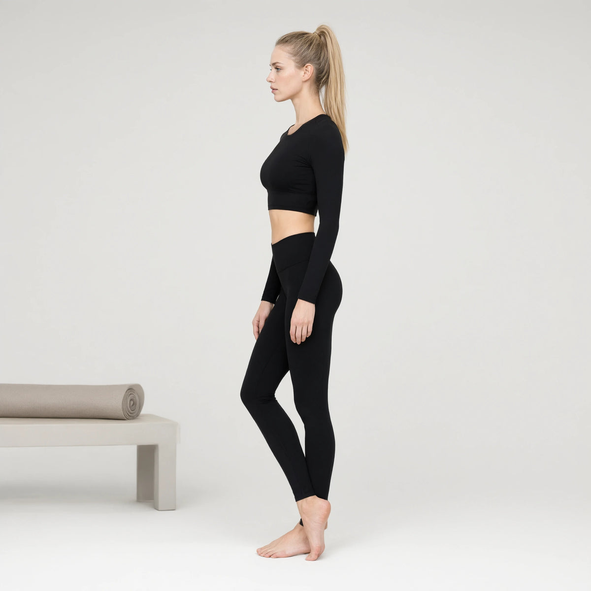 Black | Long Sleeve Sports Running Crop Top｜DUVETMOON – side view (ankles gently crossed)