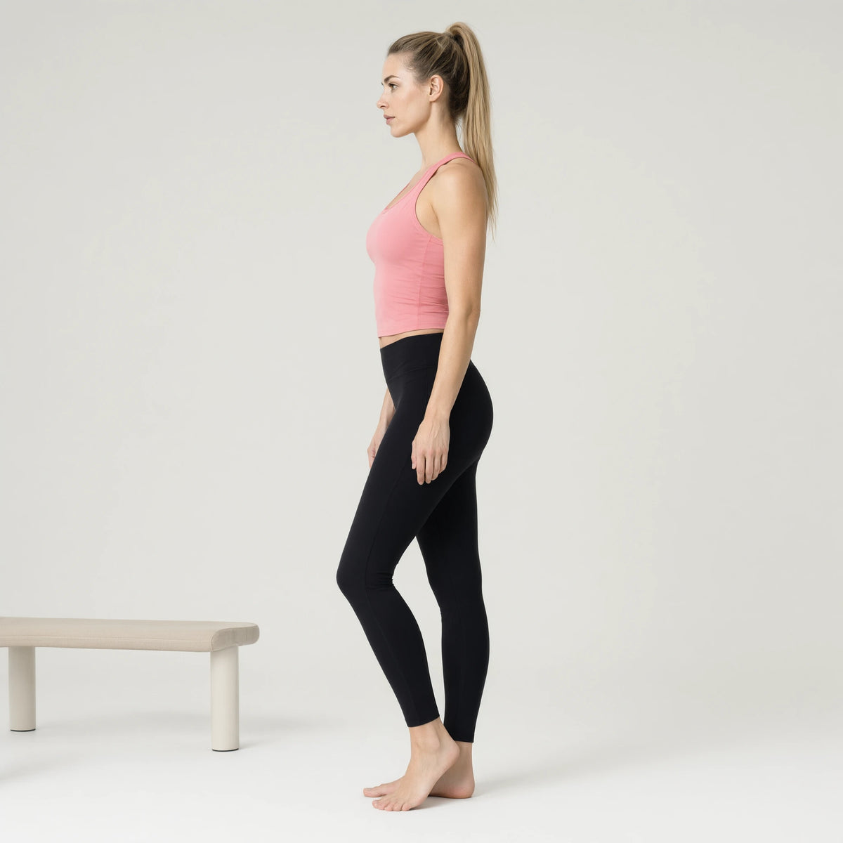 Pink | Fisoew Workout Tank Tops Sleeveless Scoop Neck Racerback｜DUVETMOON – side view (ankles gently crossed)