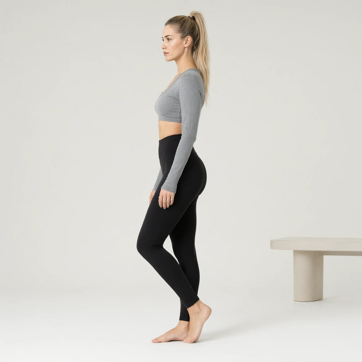 Rhino Grey | Comfortable Nude Yoga Top Long Sleeve｜DUVETMOON – side view (ankles gently crossed)