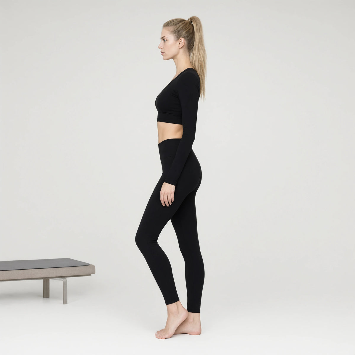 Black | Long Sleeve Yoga Wear Top｜DUVETMOON – side view (ankles gently crossed)