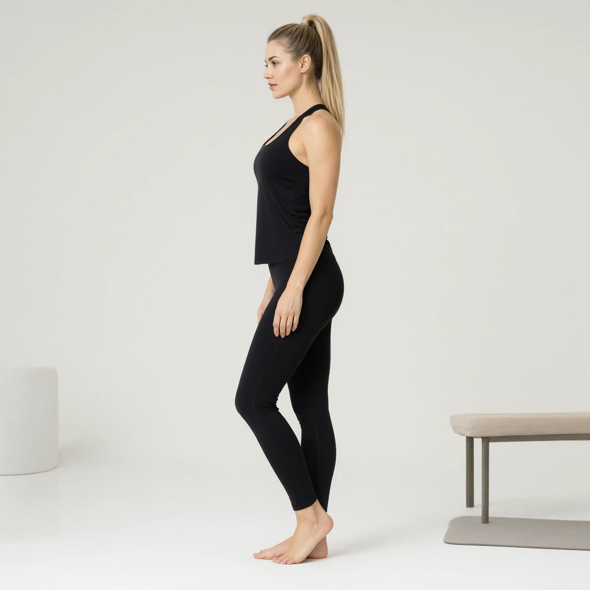 Black | Quick Dry Yoga Tank Top Loose Back Split｜DUVETMOON – side view (ankles gently crossed)
