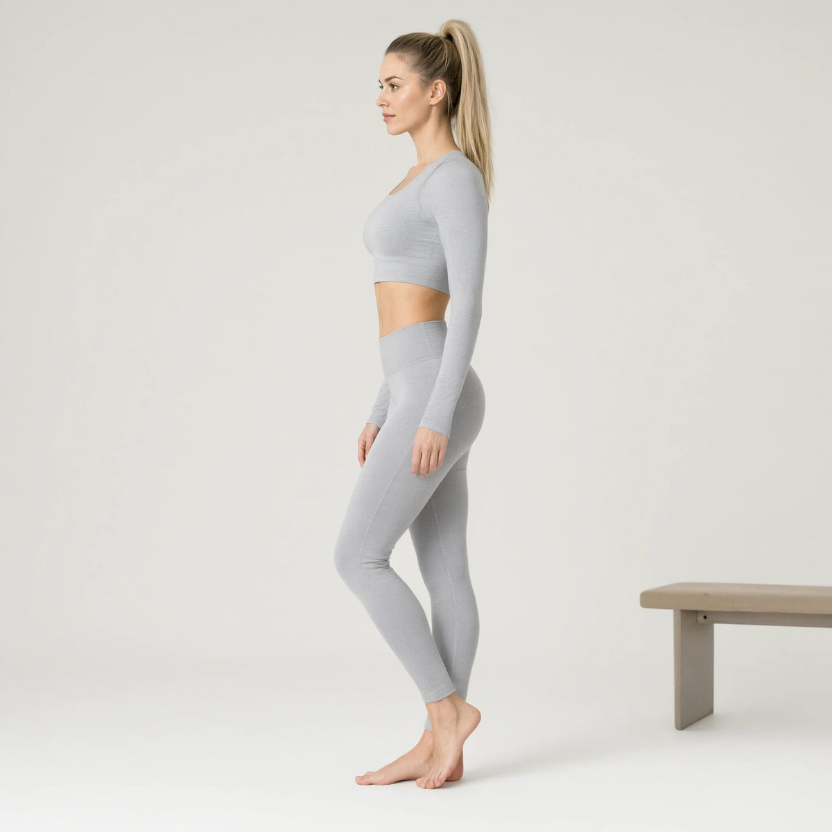 Light Grey | Running Yoga Navel Seamless Long Sleeve Top｜DUVETMOON – side view (ankles gently crossed)