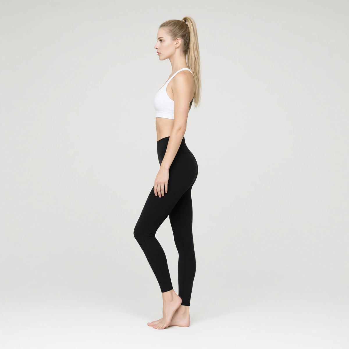 White | Padded Yoga Vest Tight Waist Length Tank Top｜DUVETMOON – side view (ankles gently crossed)