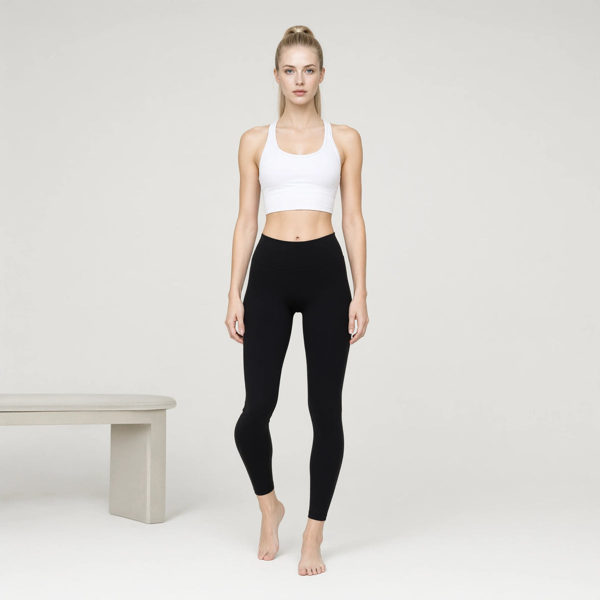 White | Padded Yoga Vest Tight Waist Length Tank Top｜DUVETMOON – front view (one foot stepped half a pace forward)