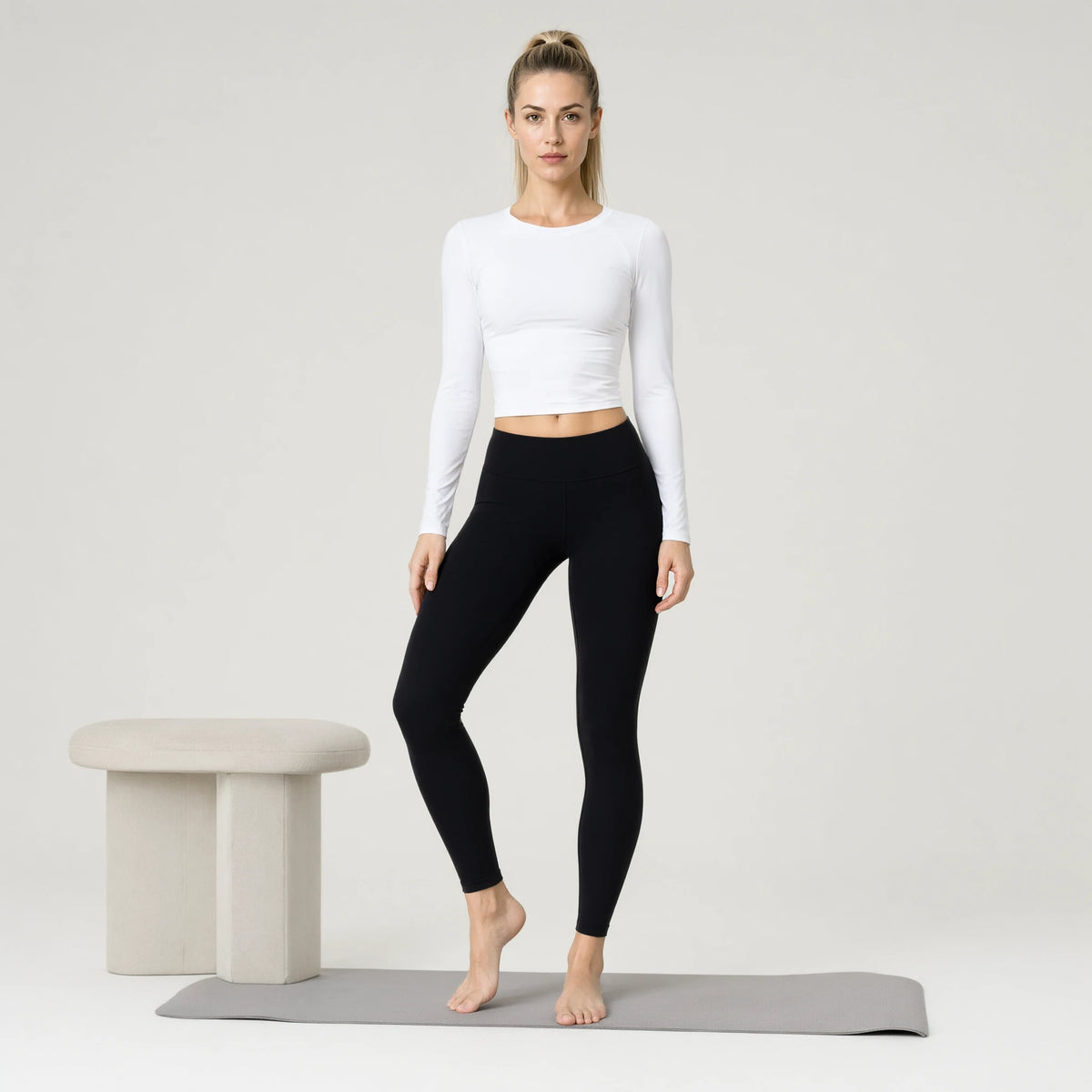 White | Long Sleeve Yoga Wear Outdoor Sports Top｜DUVETMOON – front view (one foot stepped half a pace forward)