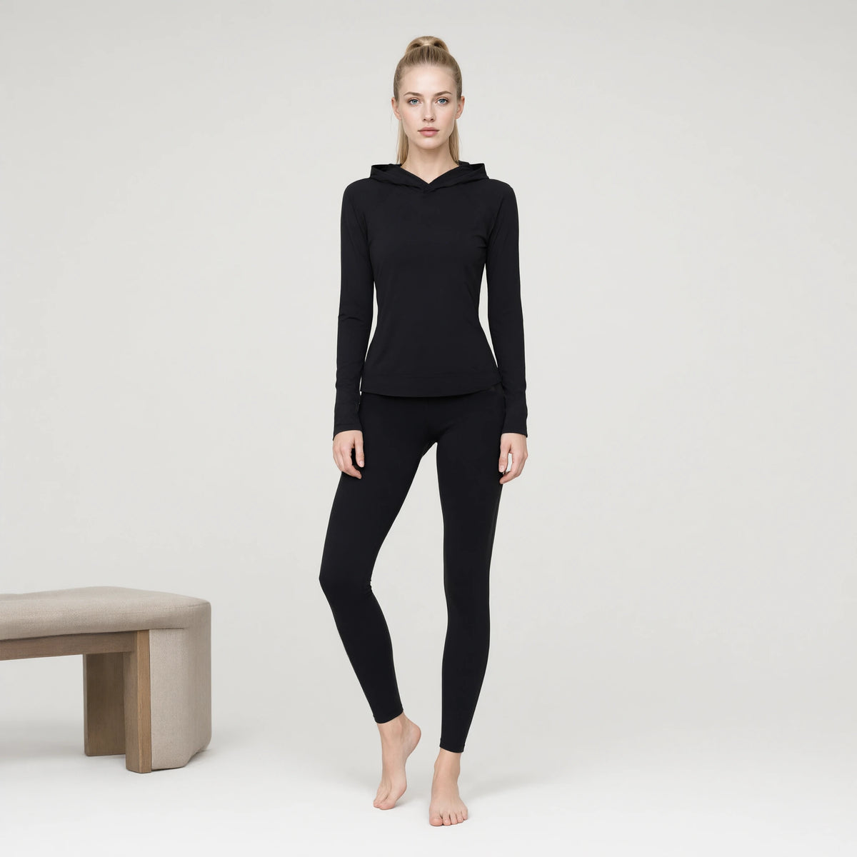 Black | Long Sleeve Hooded Yoga Top｜DUVETMOON – front view (one foot stepped half a pace forward)