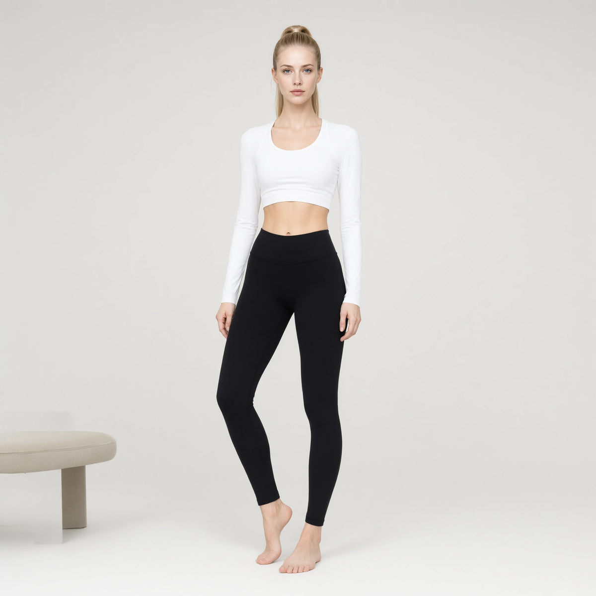 White | Long Sleeve Sports Running Crop Top｜DUVETMOON – front view (one foot stepped half a pace forward)