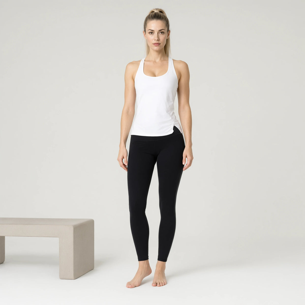 White | Quick Dry Yoga Tank Top Loose Back Split｜DUVETMOON – front view (one foot stepped half a pace forward)