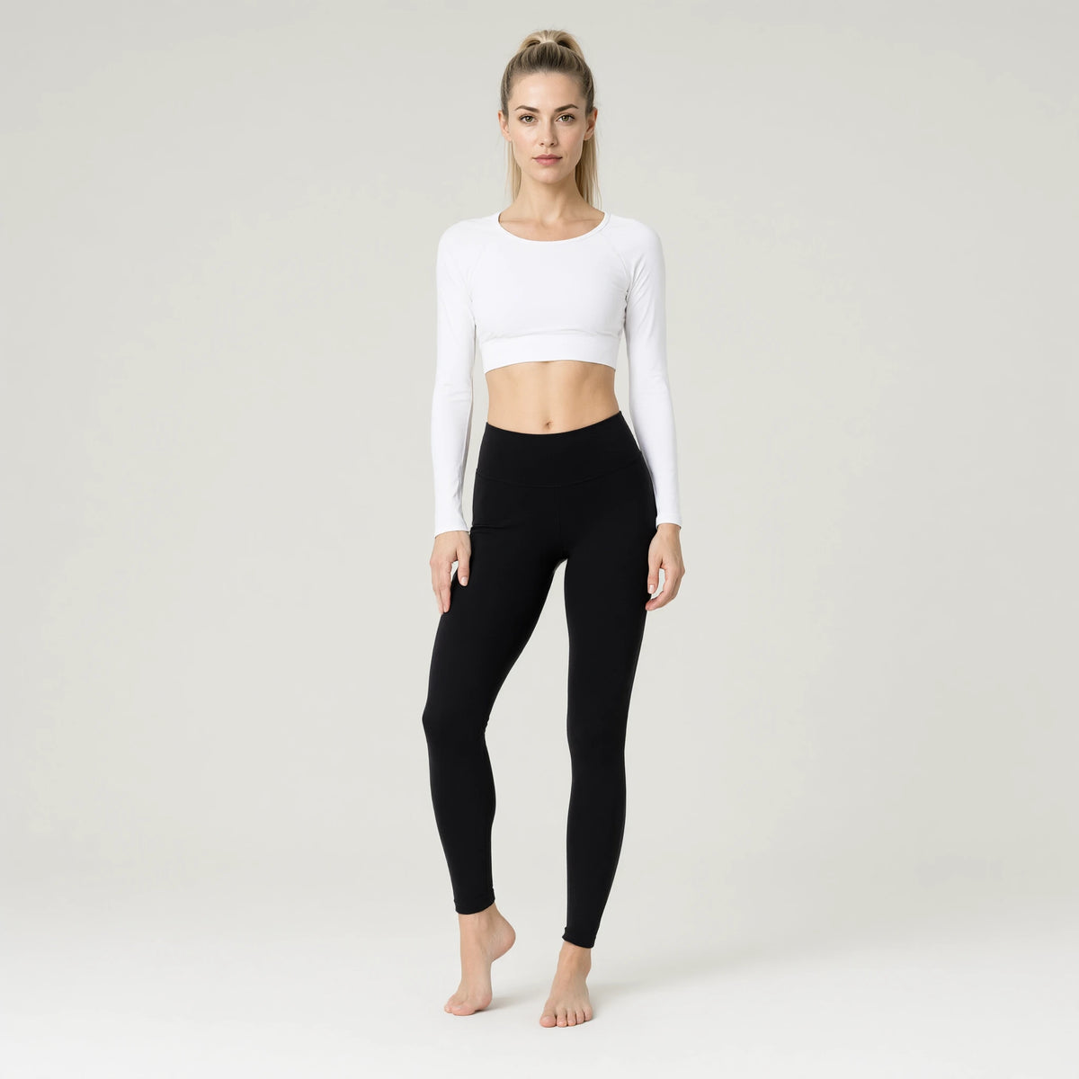 White | Long Sleeve Yoga Top｜DUVETMOON – front view (one foot stepped half a pace forward)