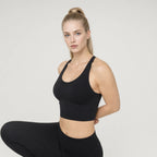 Padded Black Bra | Personality Sports Seamless Bra｜DUVETMOON – detail close-up (hands clasped behind the back)