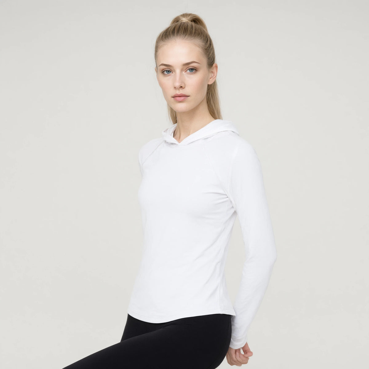 White | Long Sleeve Hooded Yoga Top｜DUVETMOON – detail close-up (hands clasped behind the back)